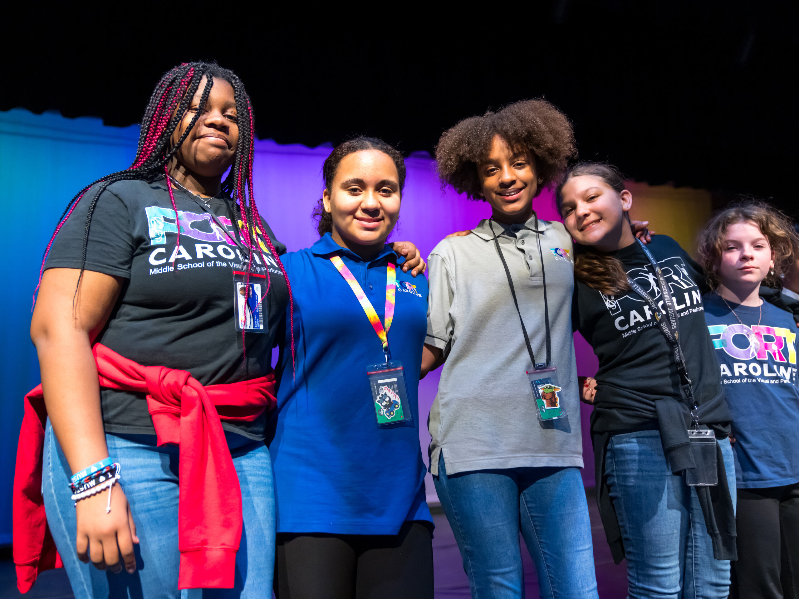 Students smiling on stage together