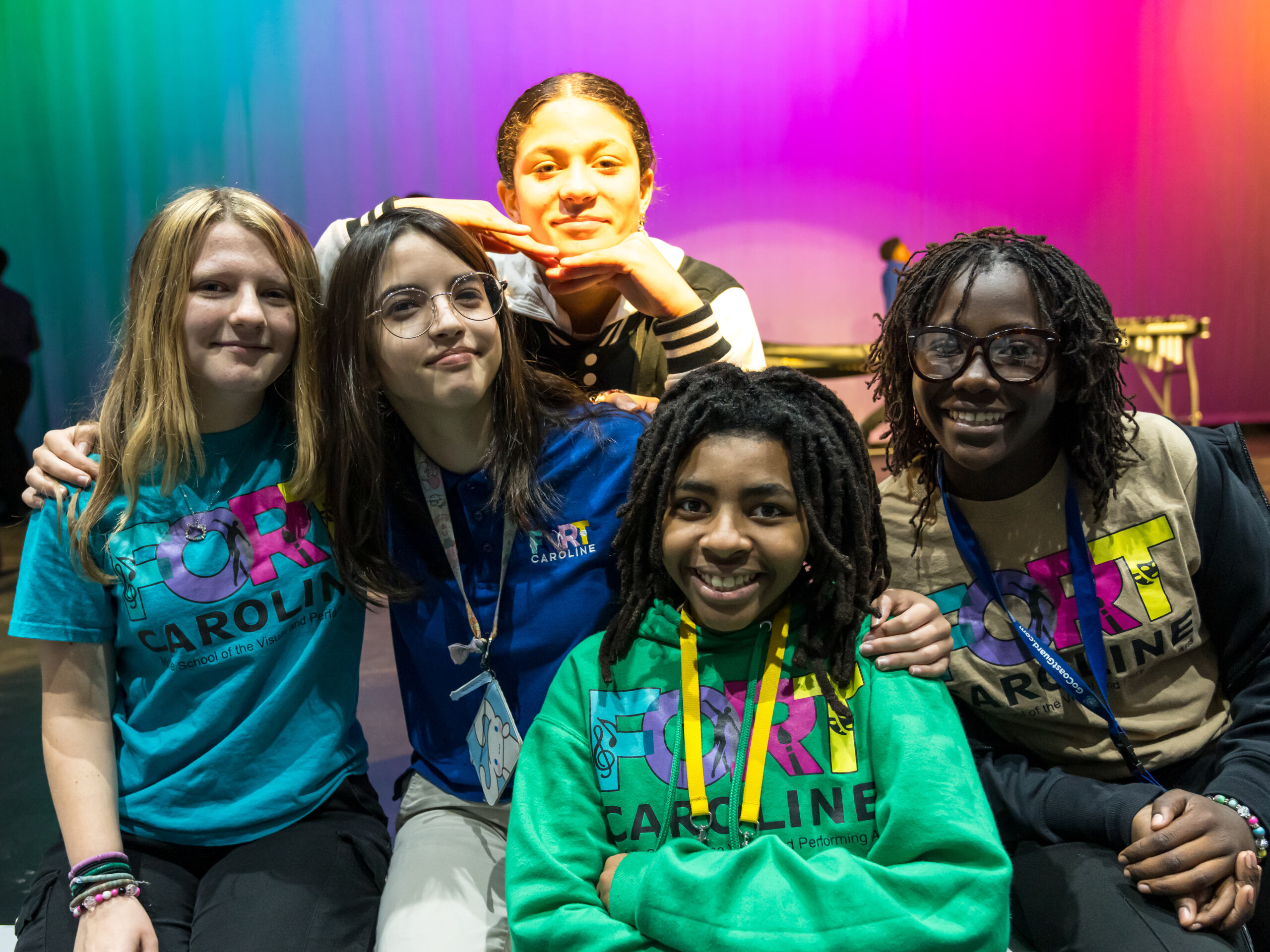 Students smiling together on stage