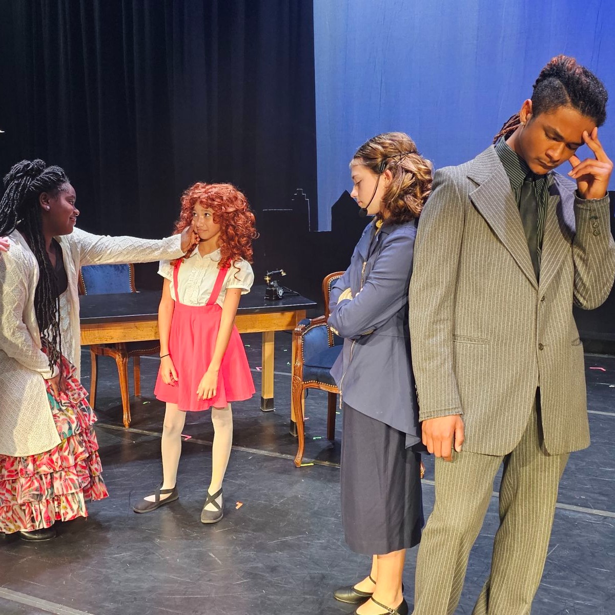 Students on stage acting out Annie