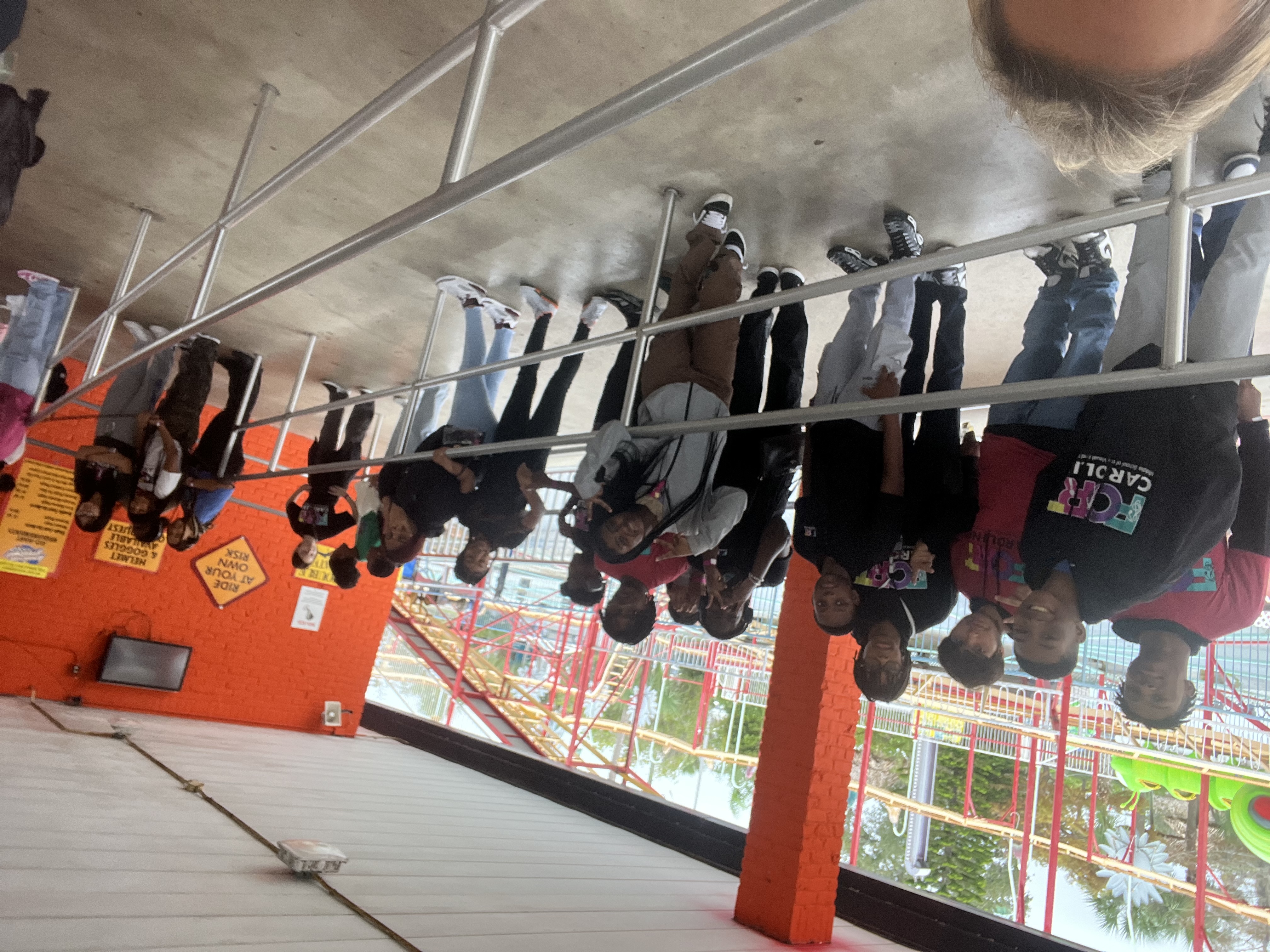 students at a theme park in line smiling