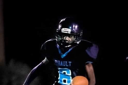 football players running with ball