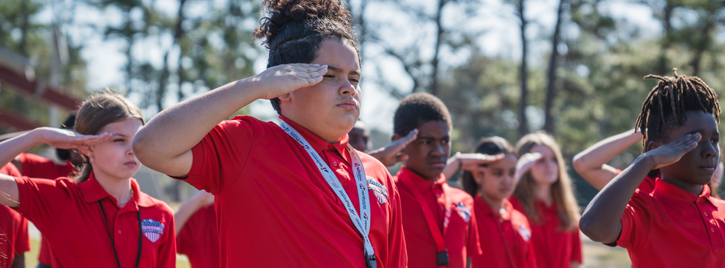 Students in formation saluting