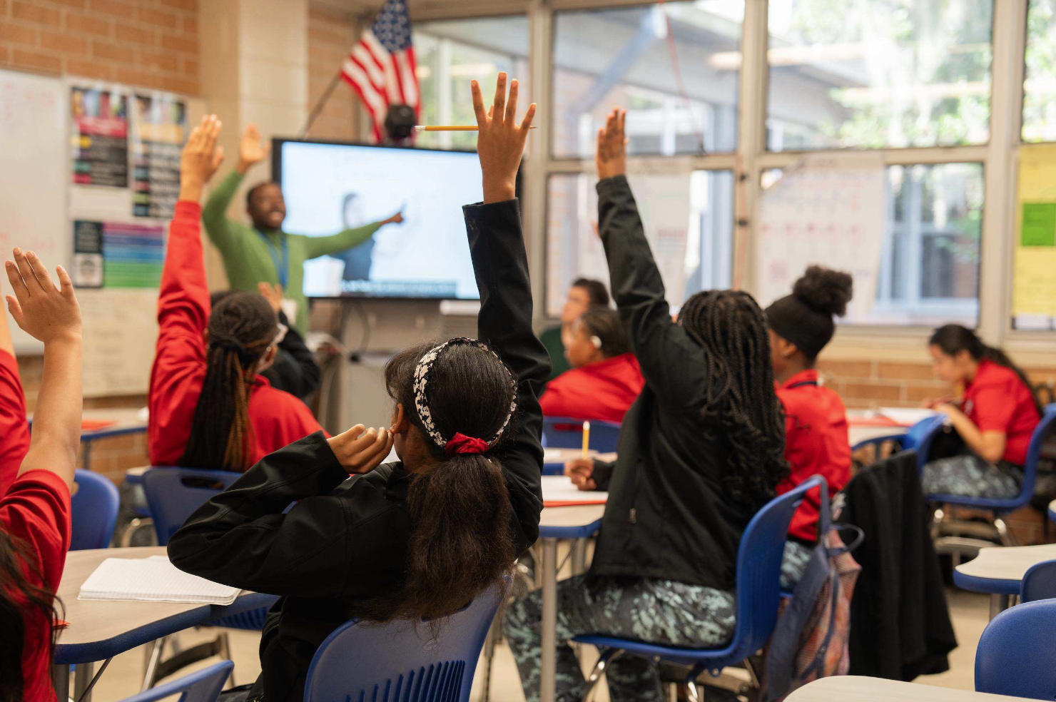 Classroom students raising their hands
