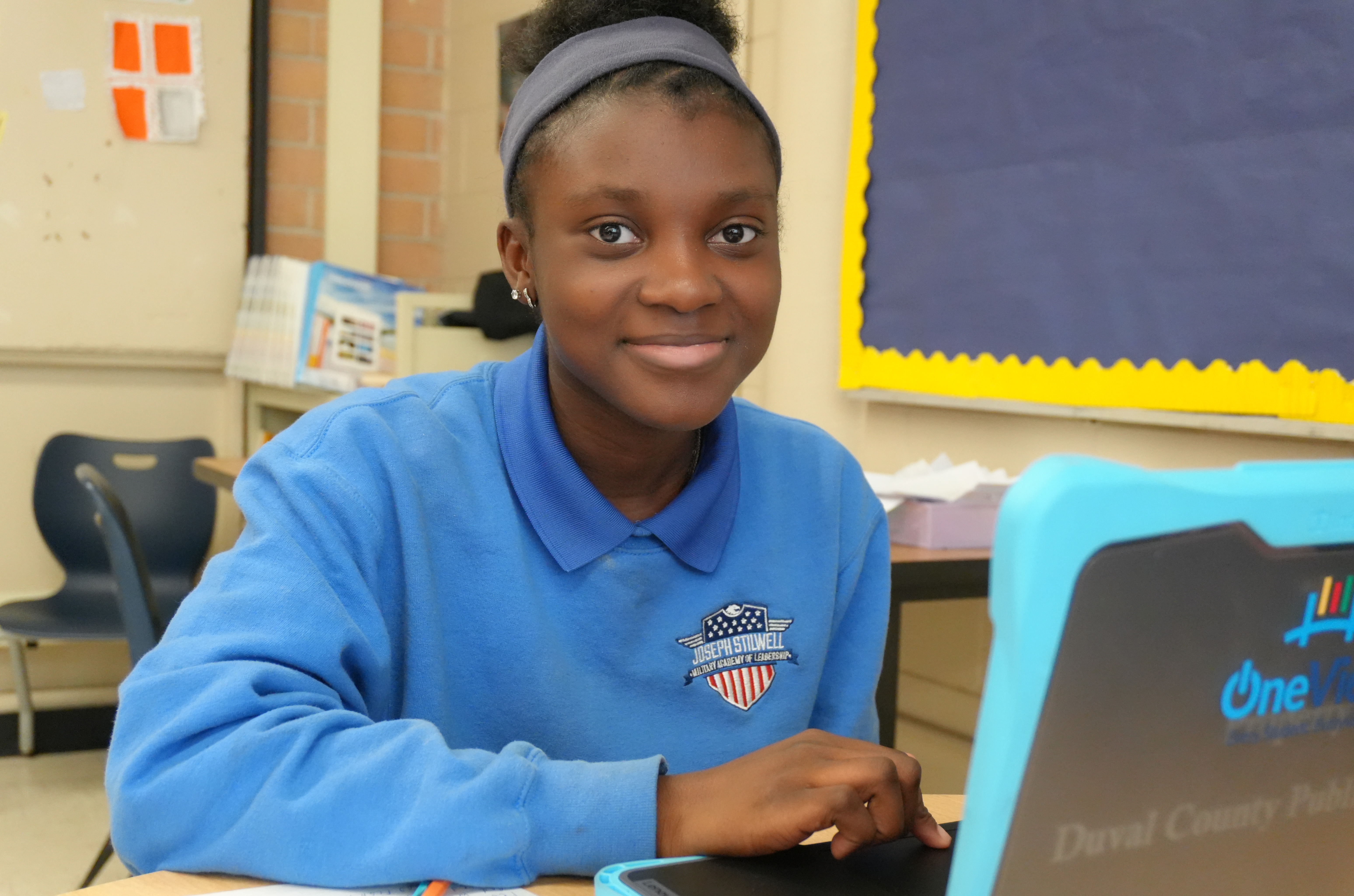 Female student smiling with laptop
