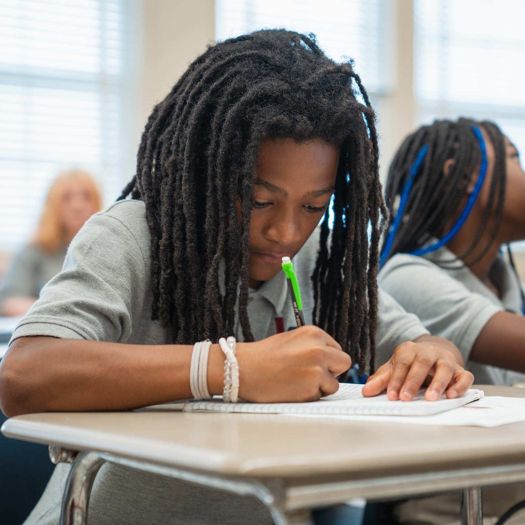 Student in school uniform working on an assignment