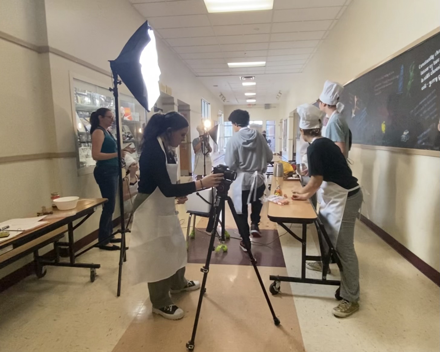 Students filming in the hallway