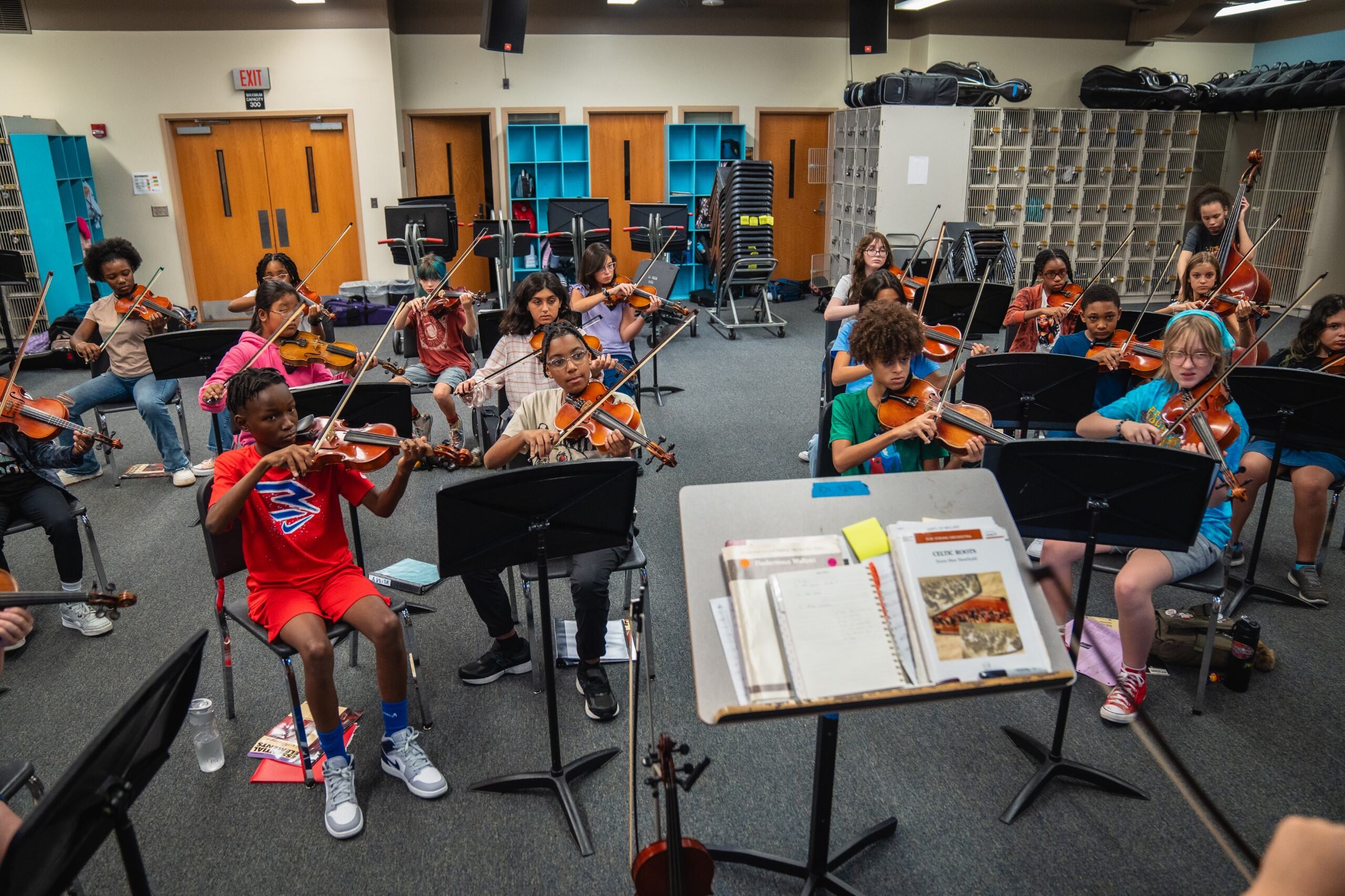 classroom of students playing violins