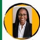 Display featuring a woman in glasses, a business suit, and a quote. Green background with a school logo and a mascot.