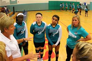 volleyball team listening to the coach