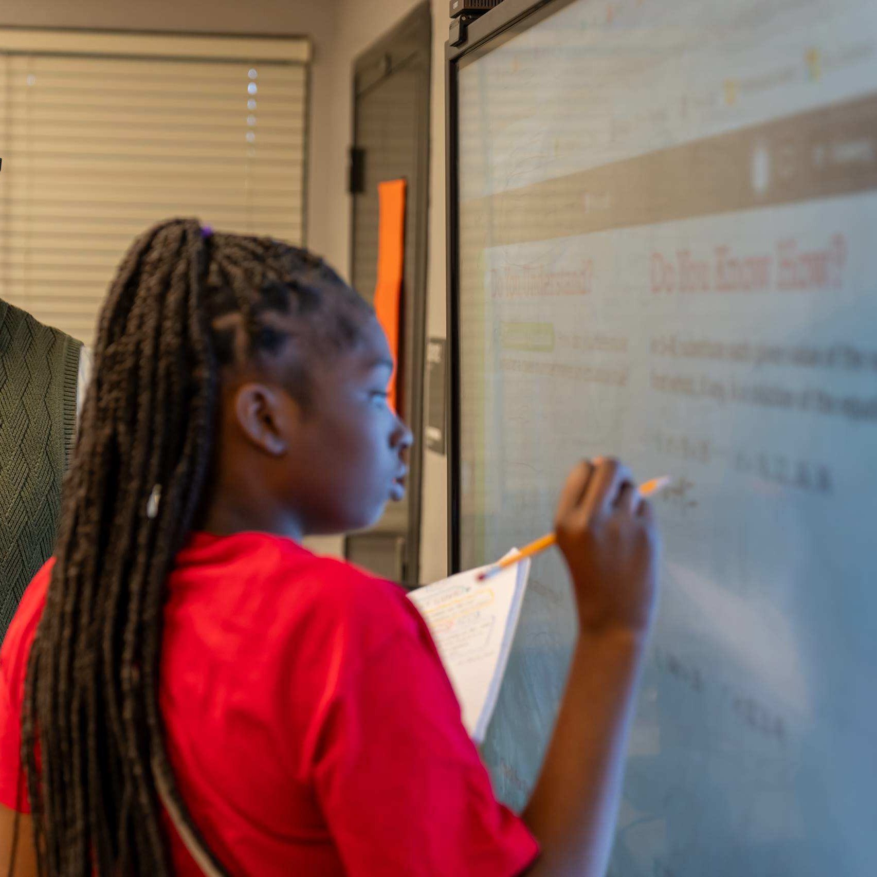 Student writing on the board