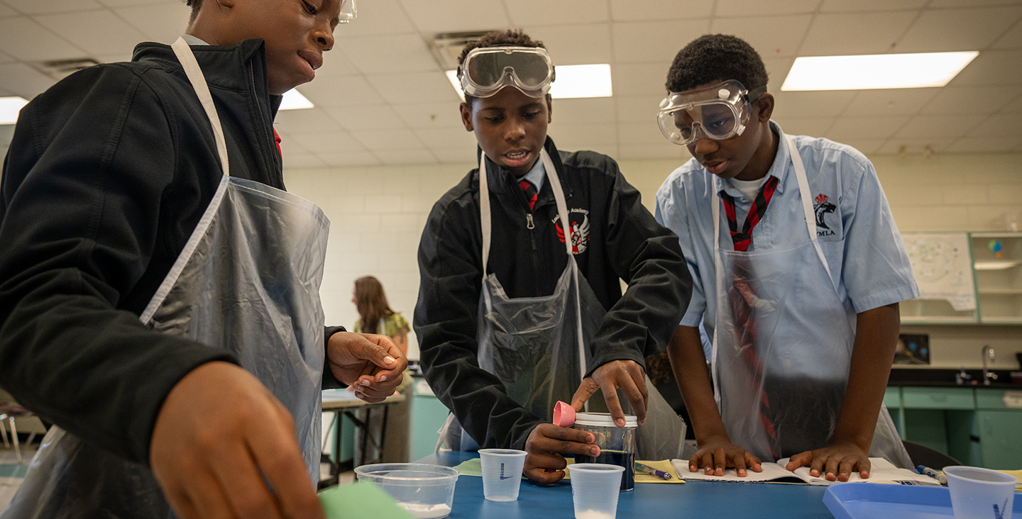 students measuring chemicals