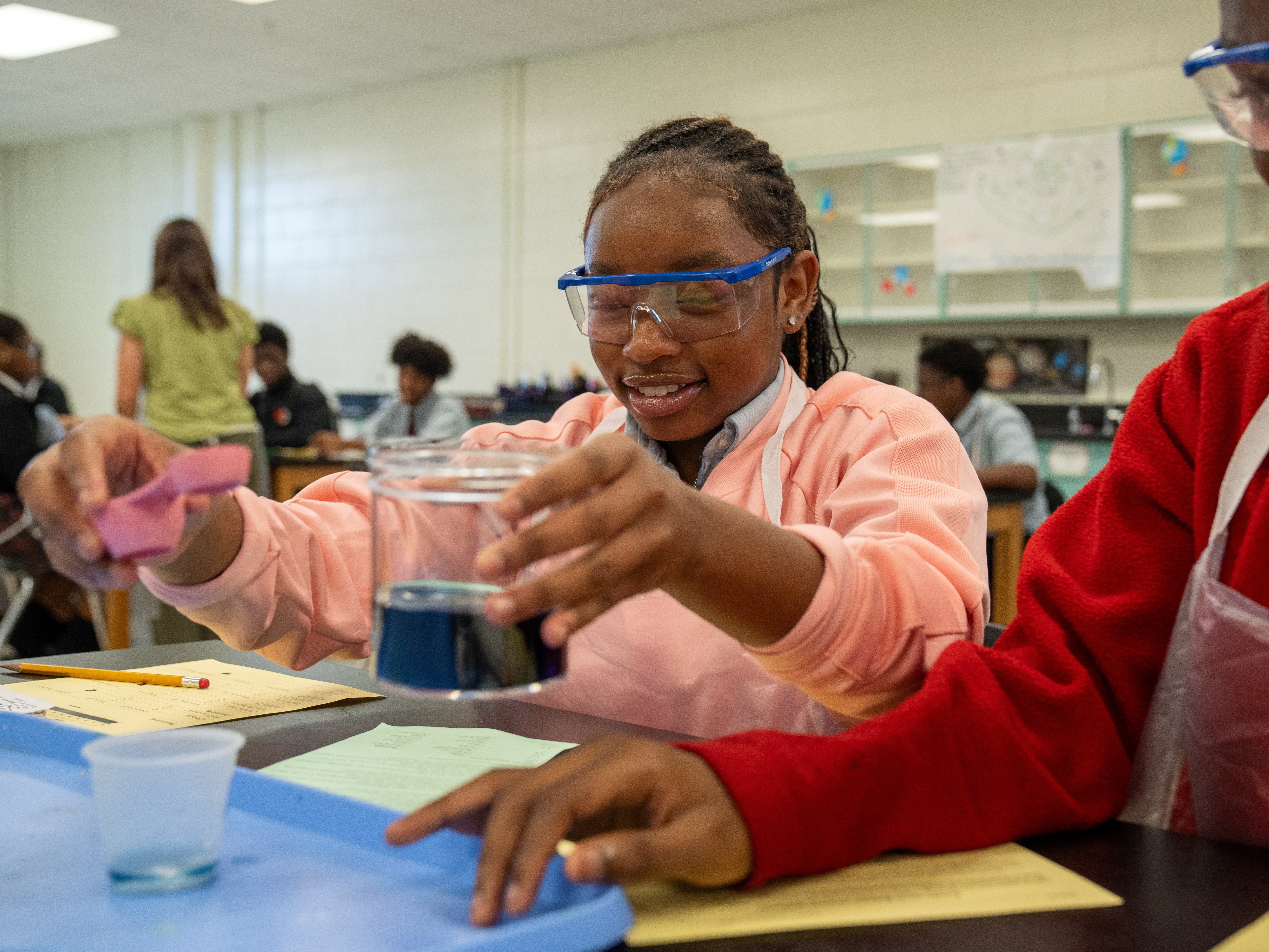 Student wearing safety goggles while engaged in a science experiment