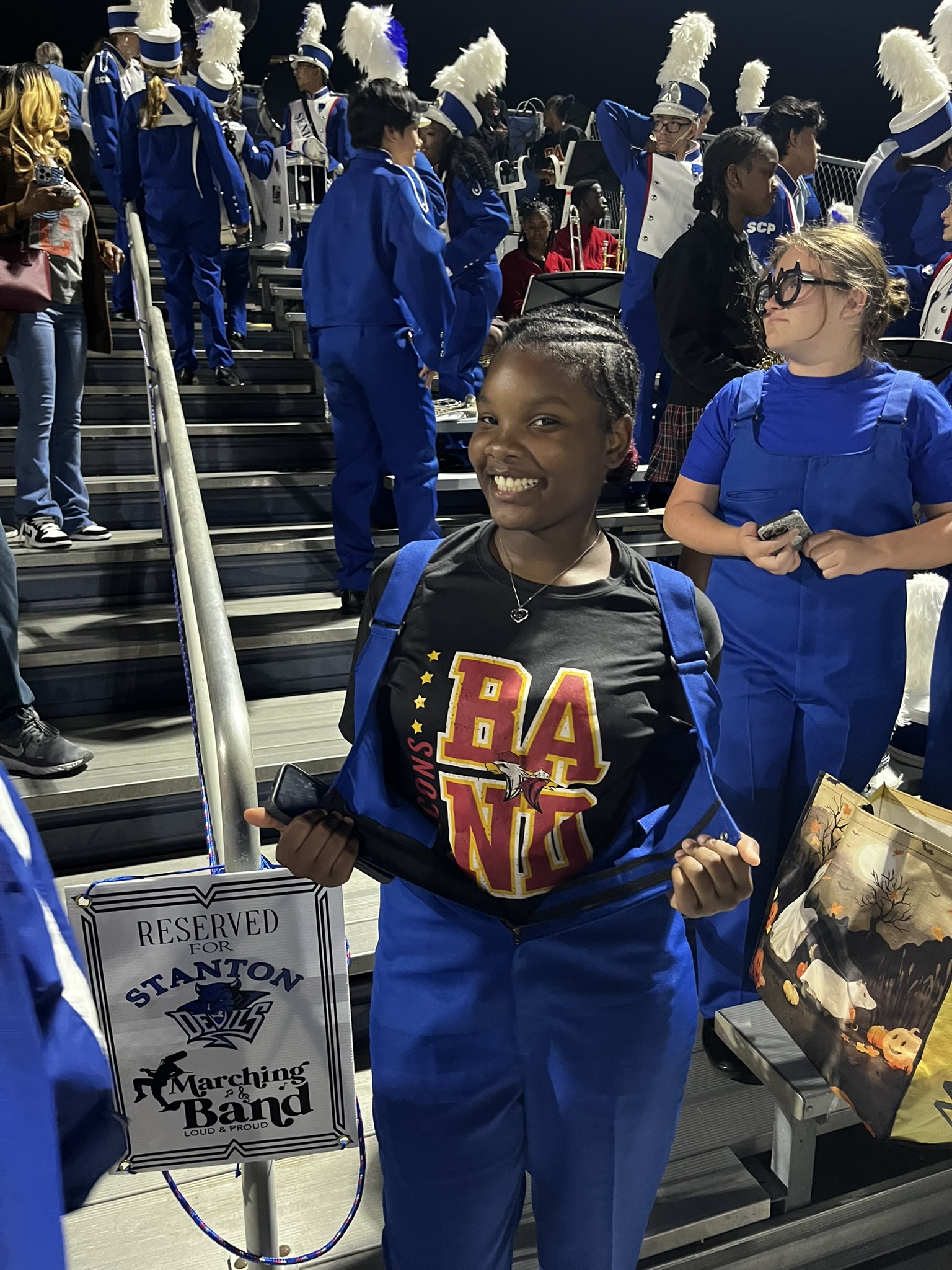 Former YMWLA student wearing her band shirt underneath her new Stanton Uniform