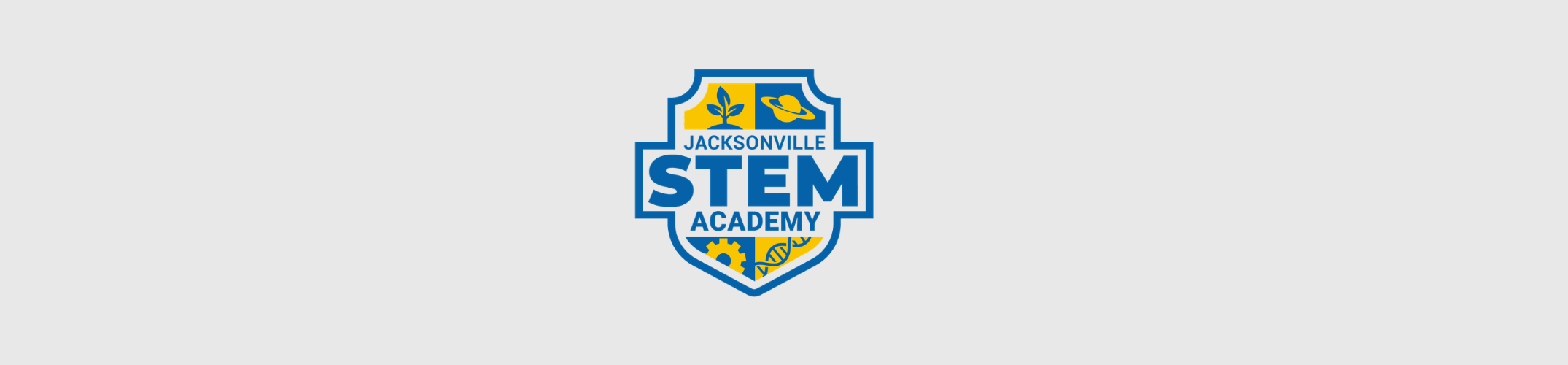 A white background displays a blue and yellow emblem. The emblem has a shield shape, with text reading "JACKSONVILLE STEM ACADEMY" in blue.
