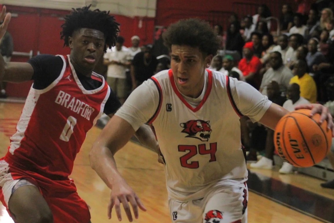 Two male athletes playing basketball