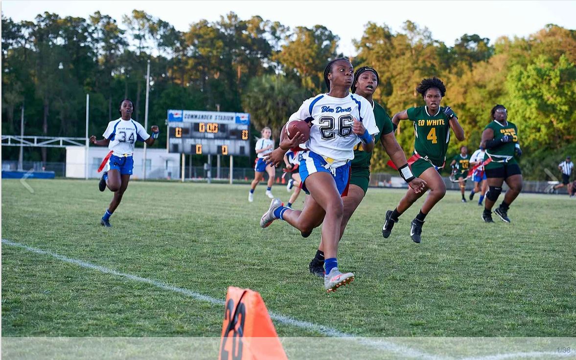 girl running holding a ball