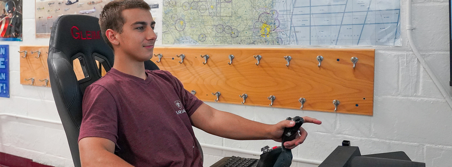 student using a flight simulator in JROTC