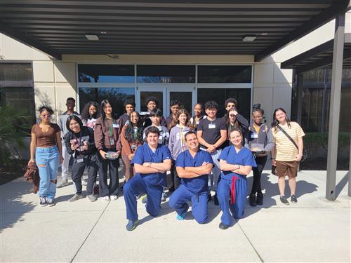 group of med students outside a hospital, posing