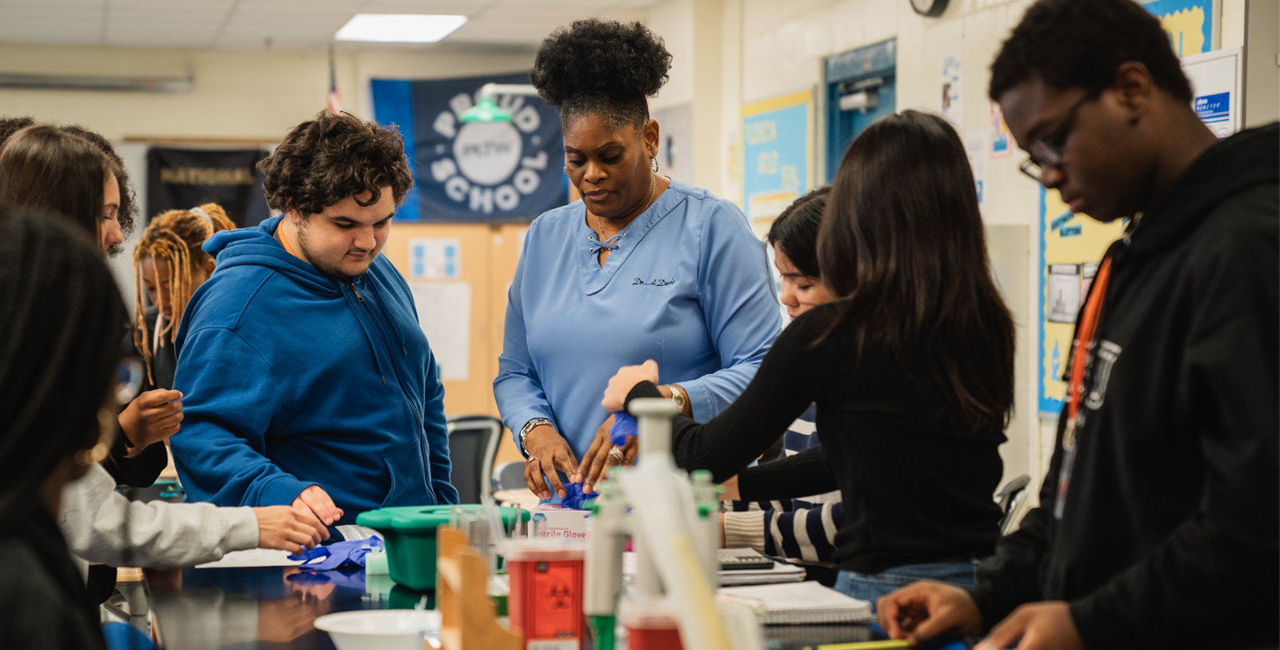 Teacher and students working together on class project