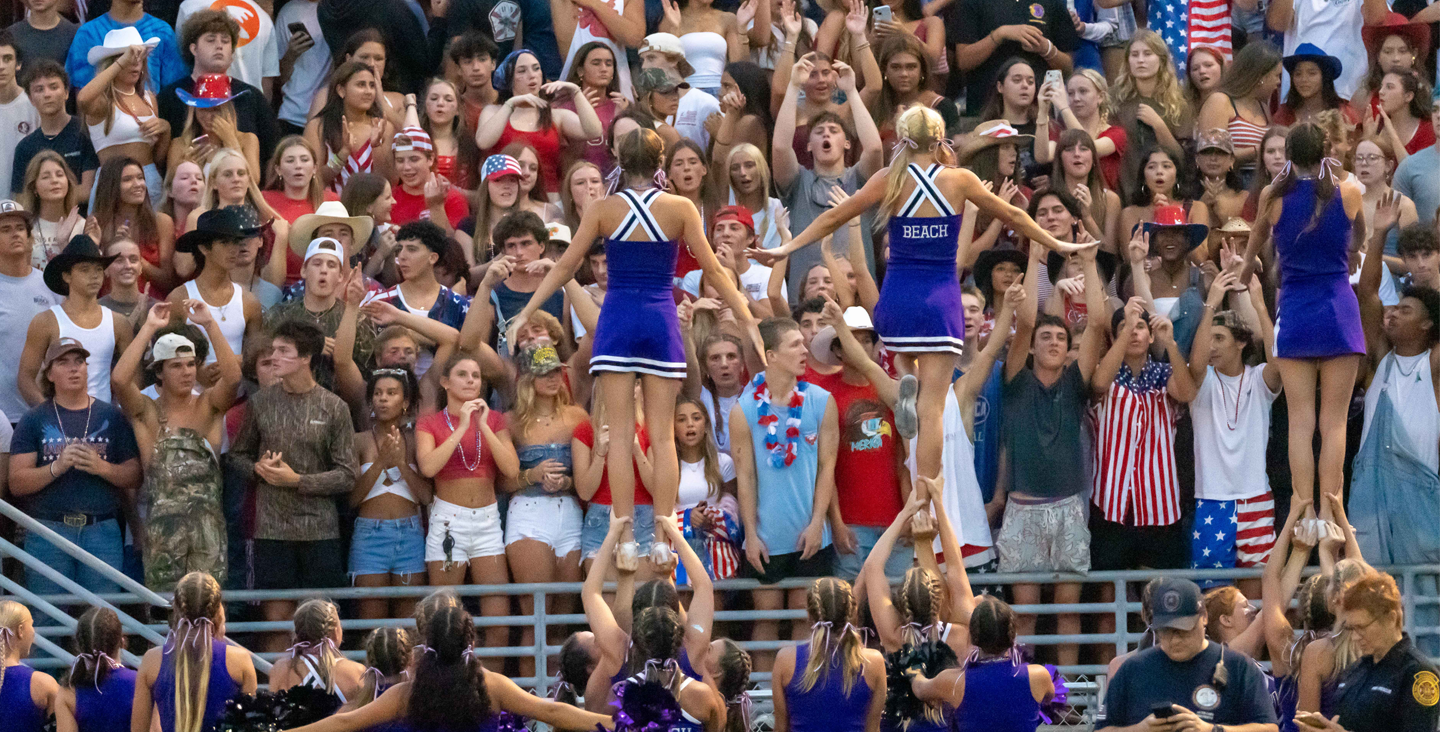 cheerleaders performing for the student section at a game