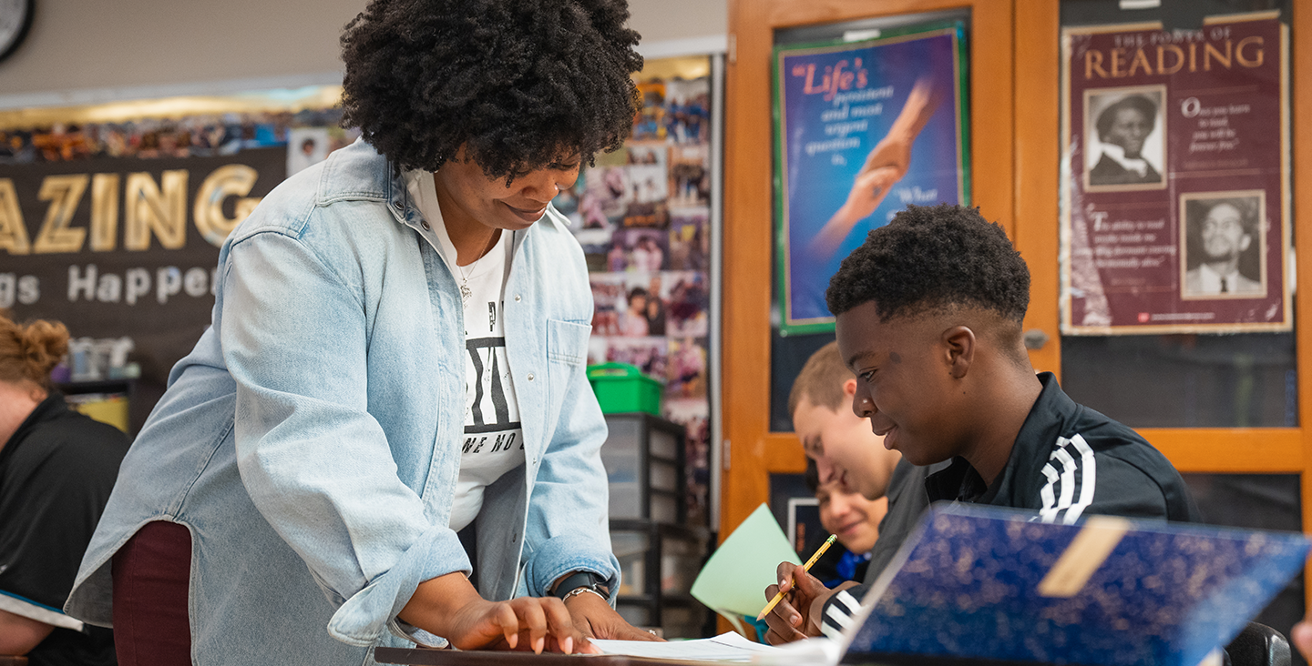 Teacher helping student with classwork