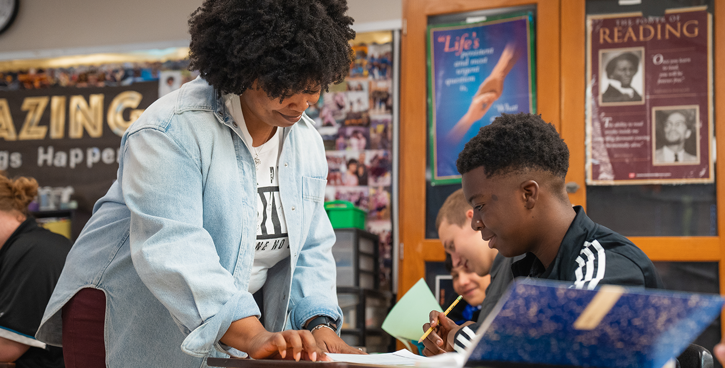 Teacher helping student