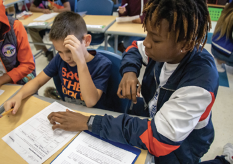 teacher helping student with activities