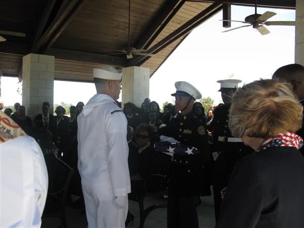 MCJROTC Cadet passes the U.S. flag during a local funeral