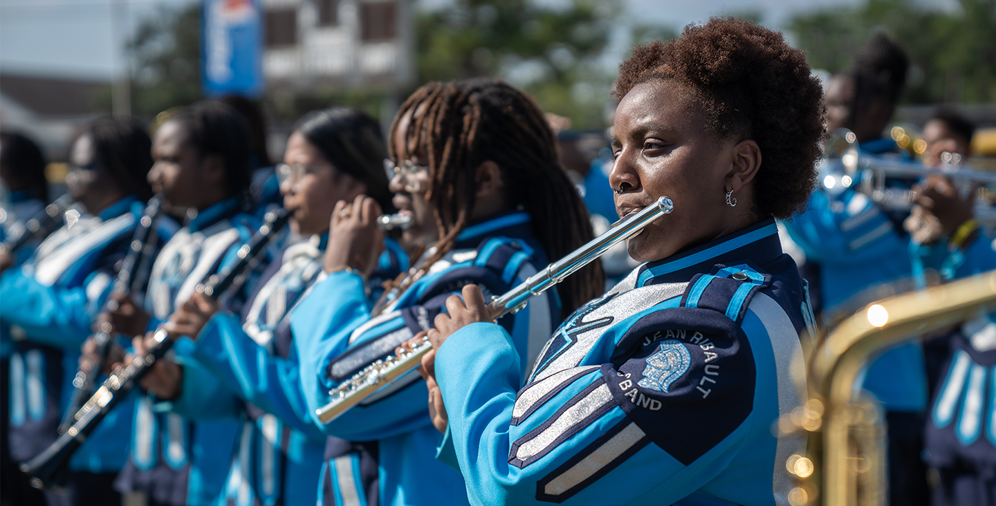 Students playing flute in the marching band