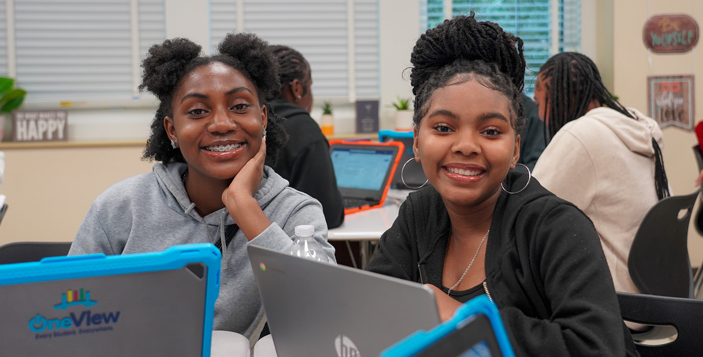 Two students smiling in class