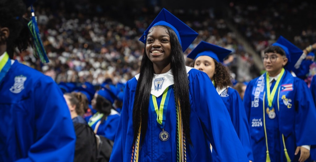 Student smiling as she graduates high school