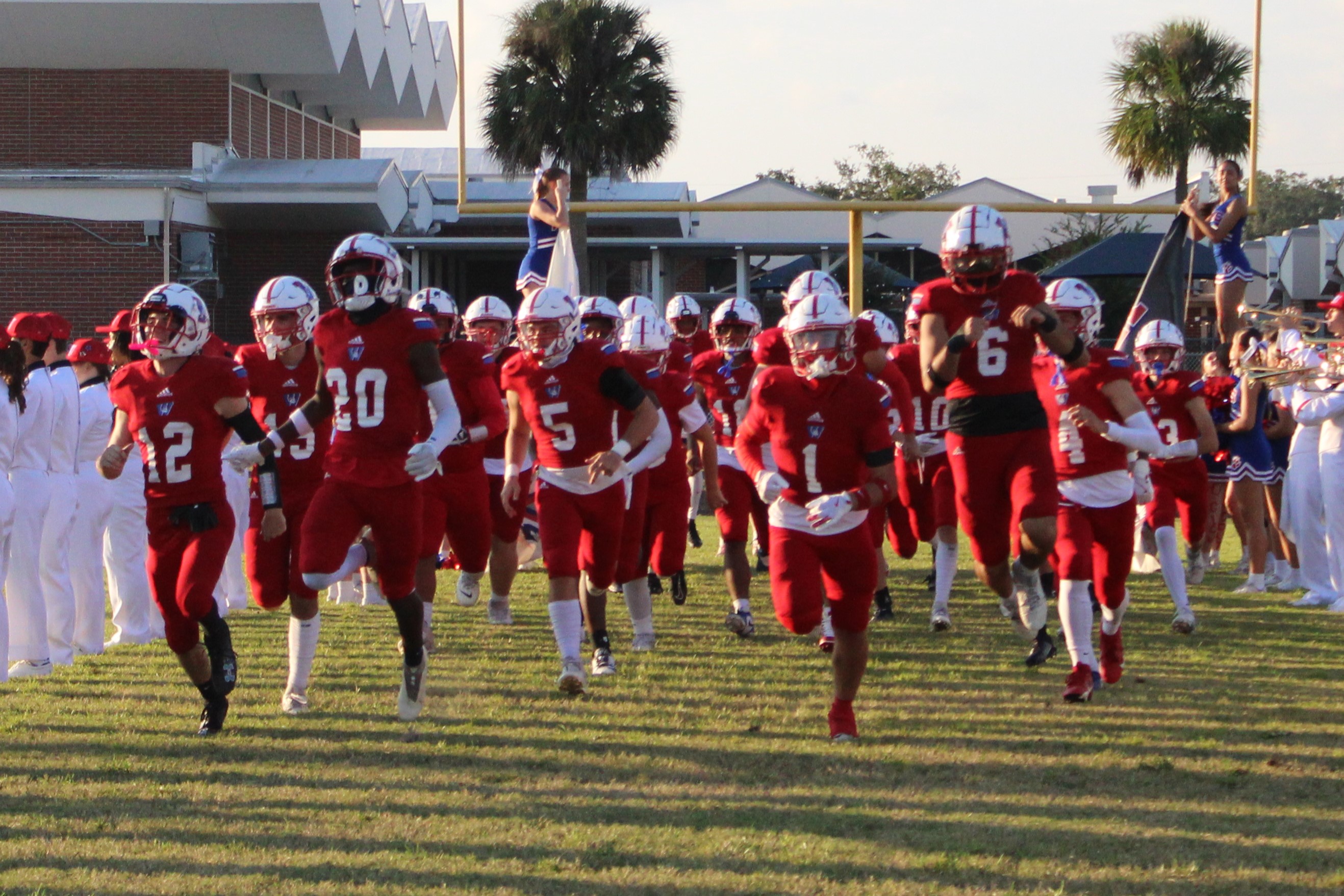 football team running onto the field