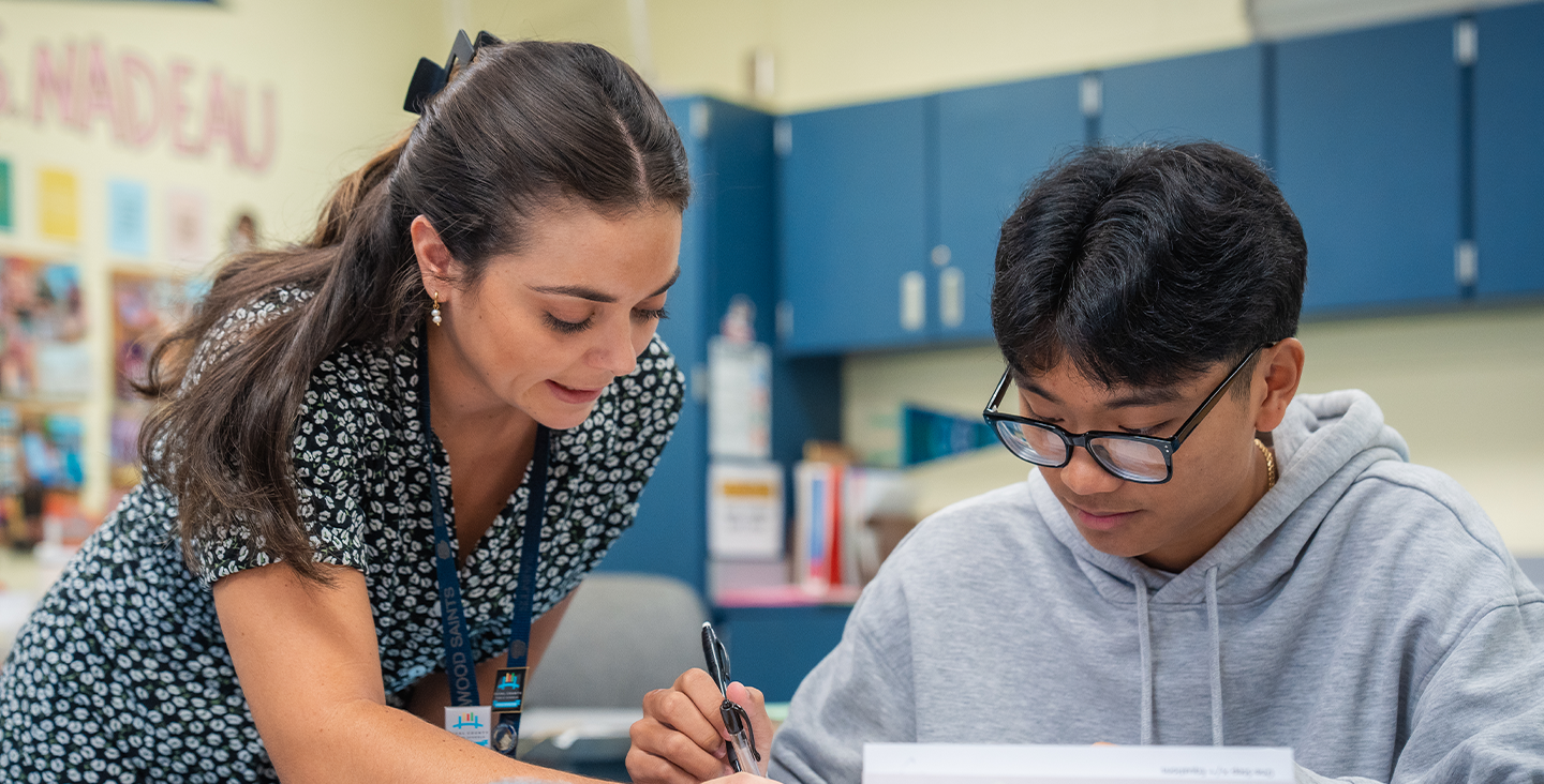 teacher helping a student with classwork