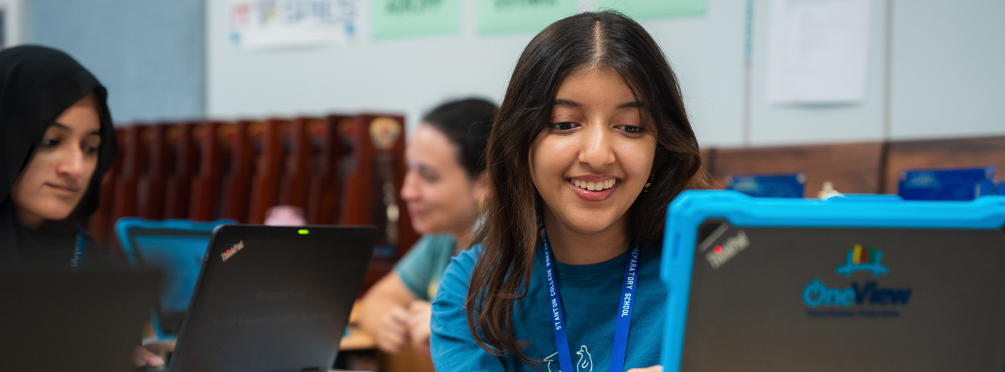 smiling student working on her laptop