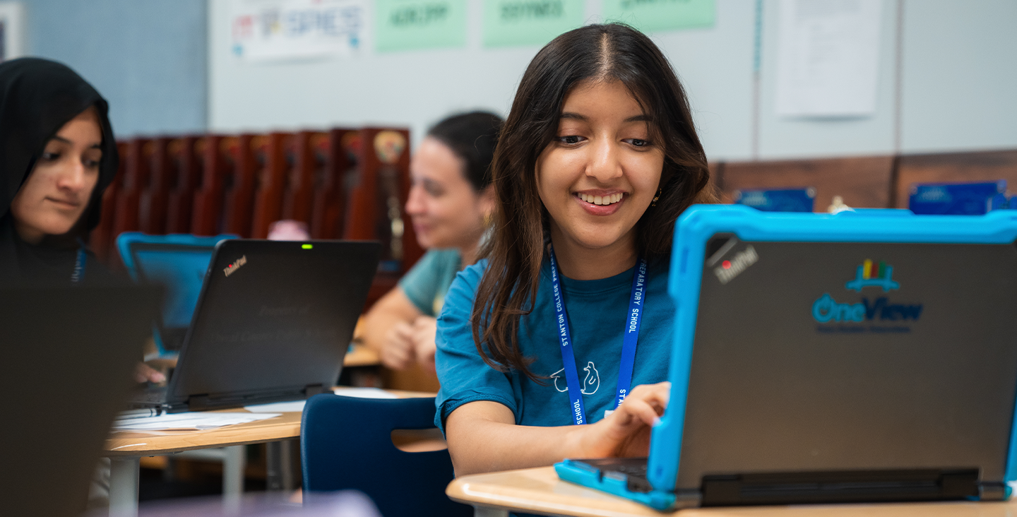 smiling student working on her laptop