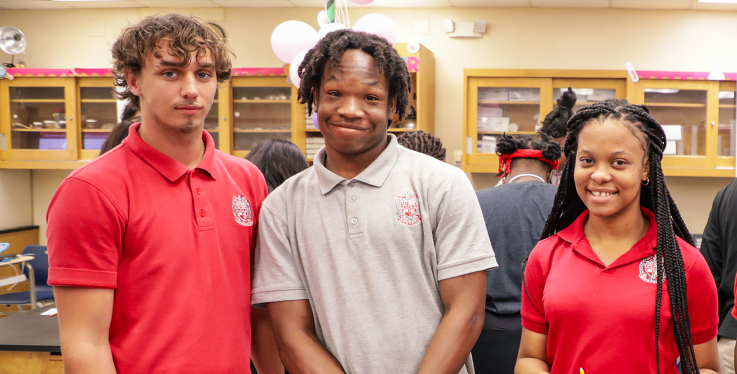 three students in a science classroom