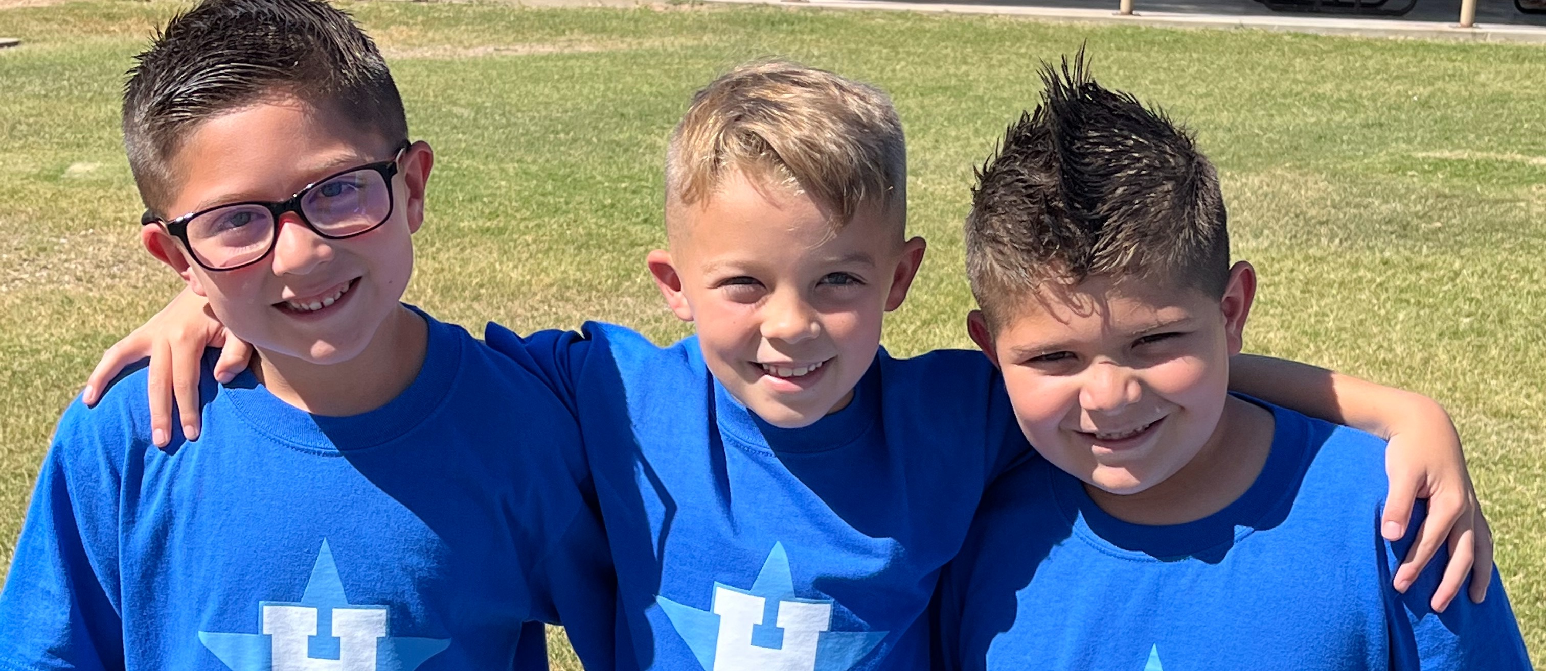 3 boys in school shirts