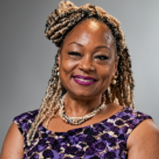 Portrait of a woman with braids, wearing a purple blouse, standing against a plain white background.