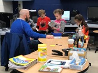 primary school students in the classroom participating with the teacher