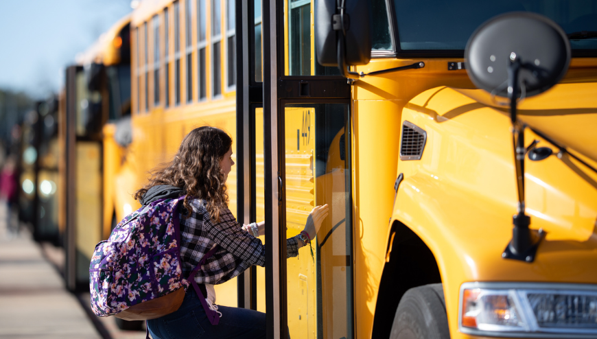 Child getting on School bus