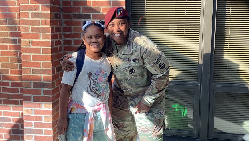 image of soldier parent standing with a child