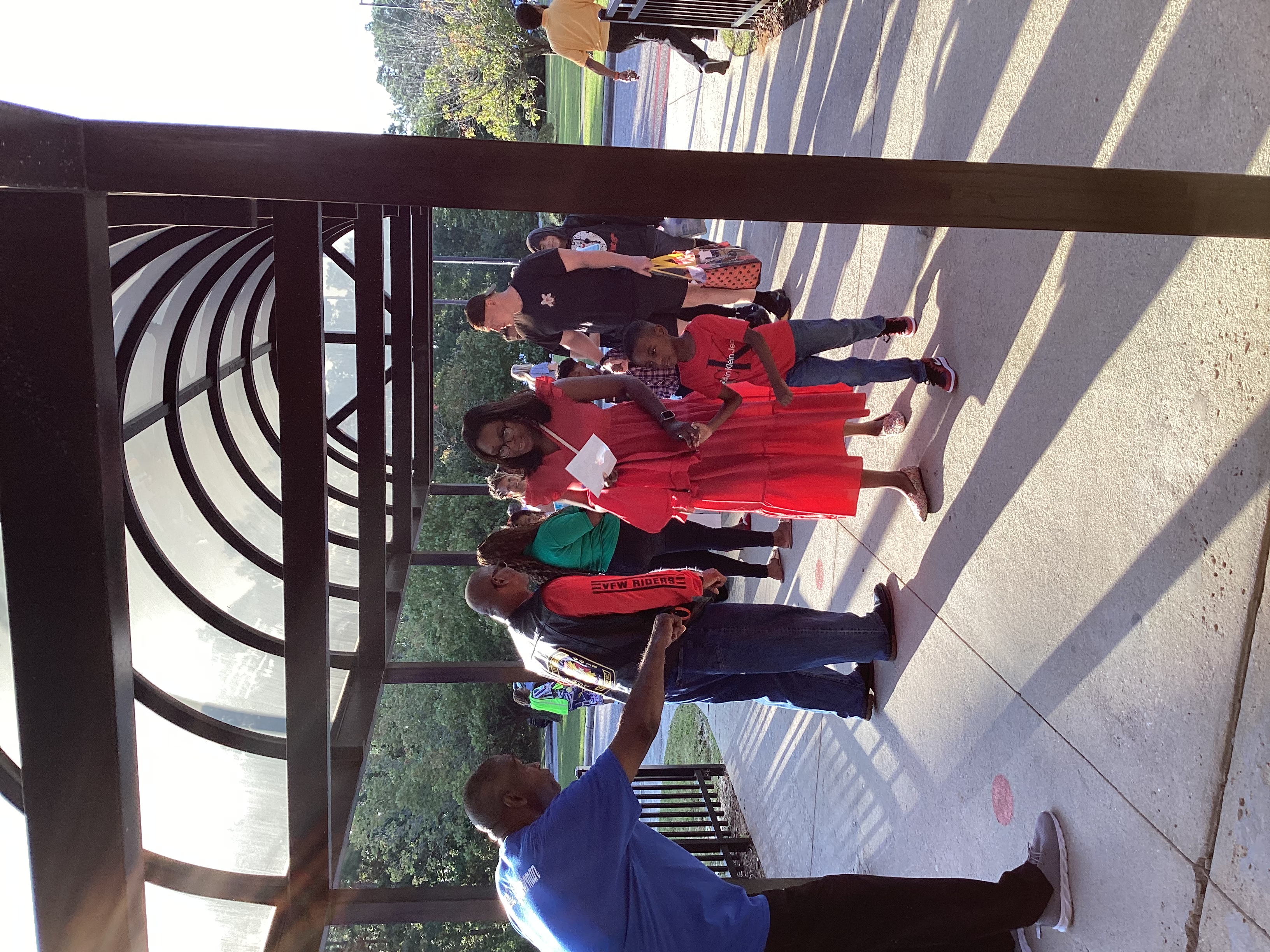 image of several adults welcoming students and parents to school