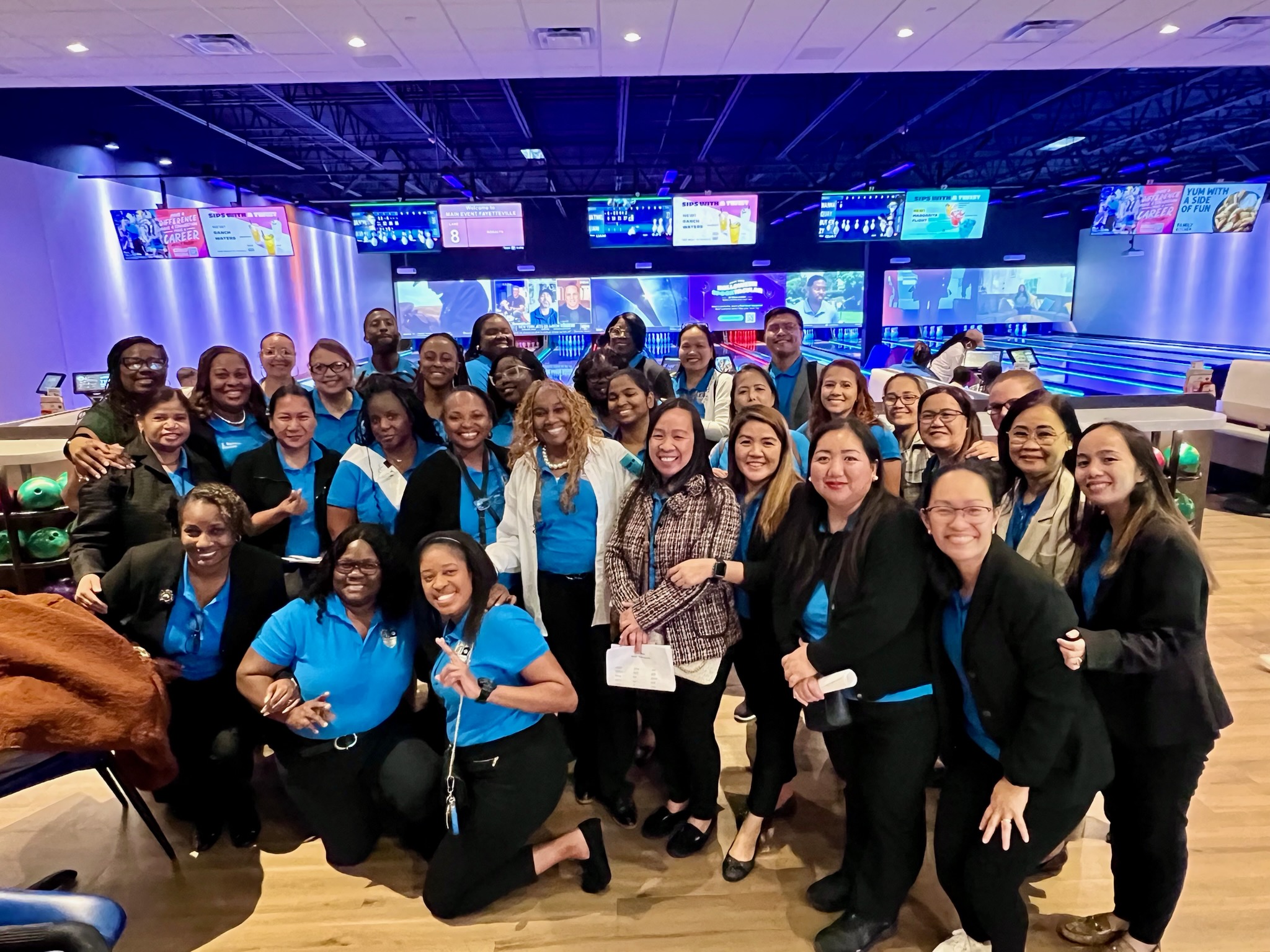  Image of a group of adults gathered at The Main Event