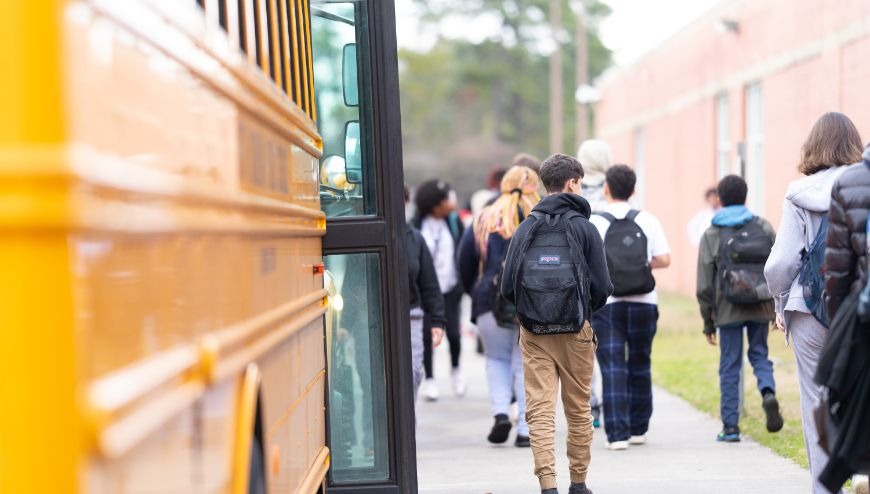 school bus dropping students at school