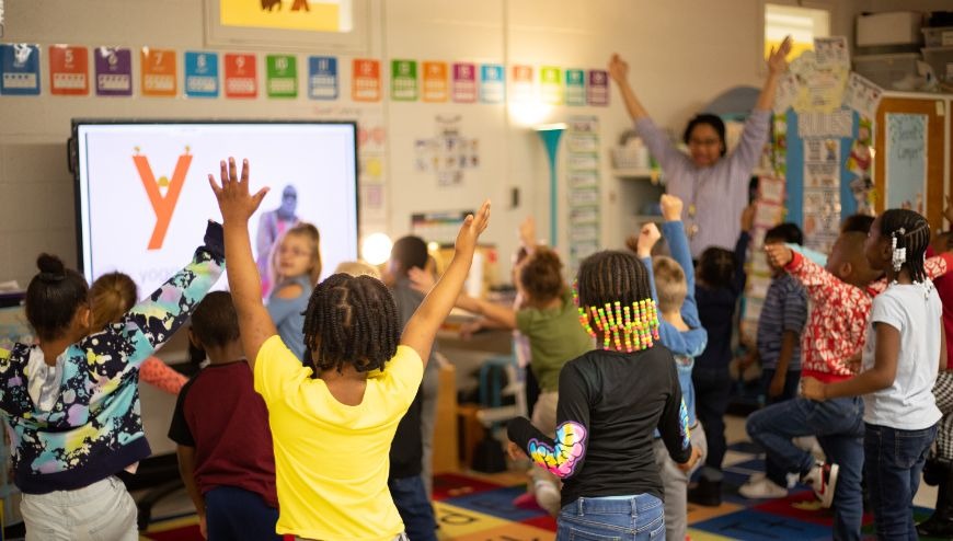 teacher with students learning the alphabet