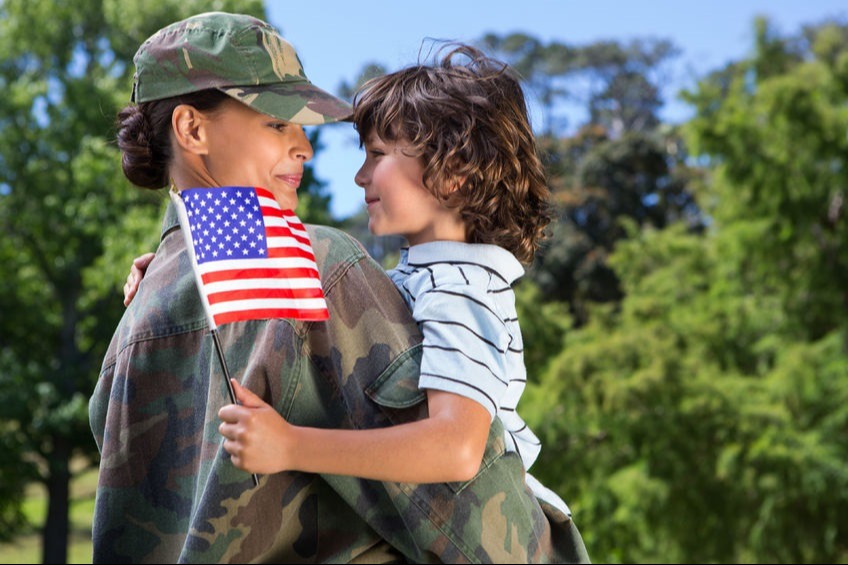solider hugging child