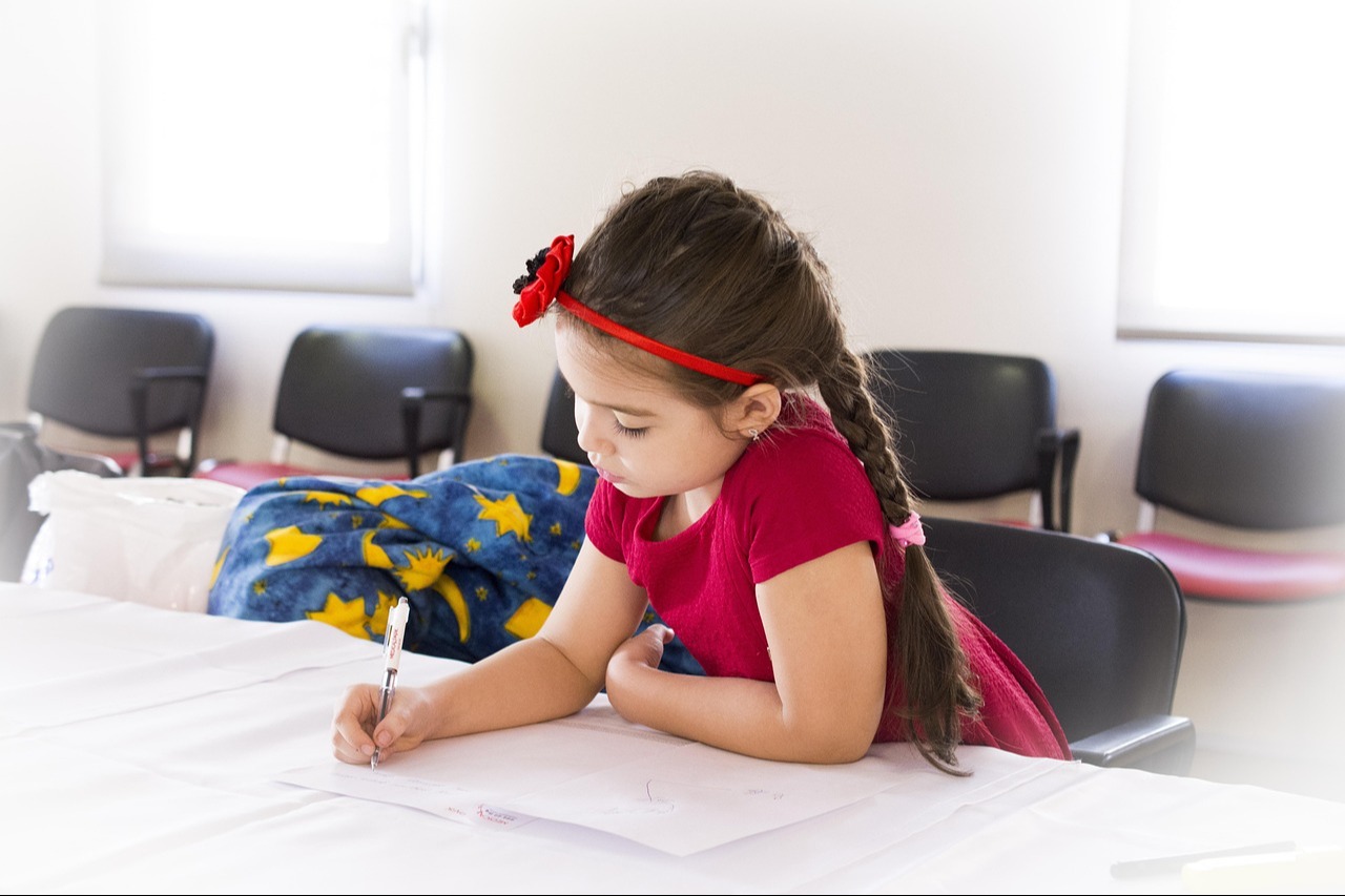 girl writing at desk