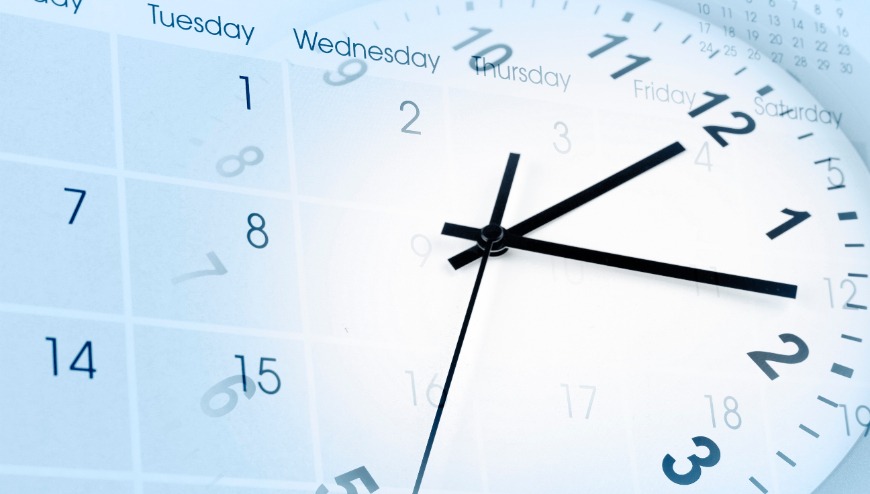 A close up photo  of a clock superimposed over a blank calendar page.