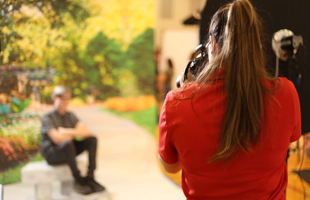 lady taking picture of sitting student