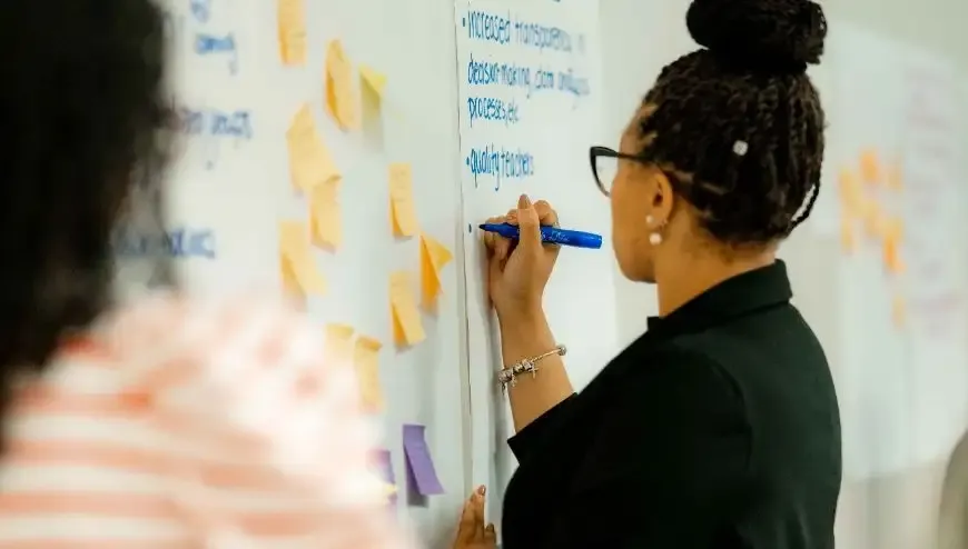 woman writing on chart paper